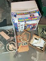 Overall lot showing play tent box, skates, racket sign, plastic tote with baskets