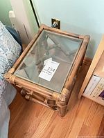Angled view showing full table beside bed, glass top visible
