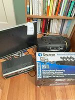 Overall lot showing Dell monitor, Swann security kit box, Panasonic boombox and additional electronics