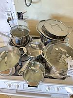 Full view of Emeril stainless cookware set on stove