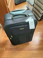 Front view of black Express softside suitcase with wheels and handle