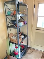 Full view of gray steel 5-shelf utility shelving unit with contents (not included).