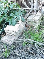 Two stacks of hollow concrete blocks in outdoor setting