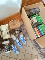 Three blue & white wall vases on rug beside other items