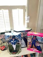 All four boxed Barbie dolls side by side