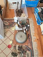 Overall lot view showing bell, bird, cast iron pieces, lace, small items