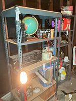 Full view of metal shelving unit with items on it