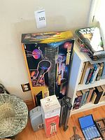 Boxed telescope, hard case, loose tripod, books for scale