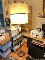 Entire floor lamp lit, showing shade, stem, base