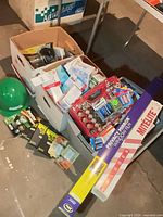 overview of boxes with battery organizer, bulbs, film roll, hard hat