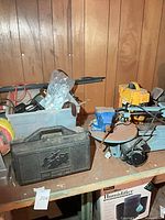 Overall view showing Delta saw, bench vise, Craftsman case and plastic bin of tools