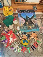 Mixed lot laid out: poster, banner, notebook, books, mugs, decorations