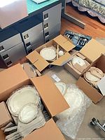 Multiple Noritake china boxes, Oneida flatware box visible