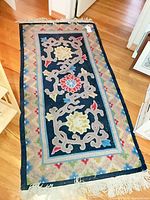 Full view of navy floral runner rug on floor