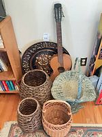 Group shot of guitar, baskets, metal plaque