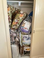 Closet showing multiple packaged queen comforter sets