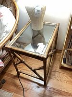 Full view of rattan side table beside bed