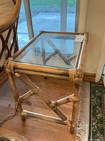 Full view of rattan side table showing glass top and frame