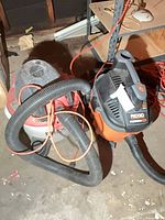Both RIDGID vacuums side by side with hoses