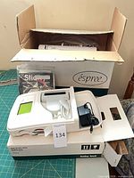 Machine, power adapter, accessory bag, manual and box visible