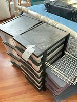 Two 5-drawer plastic towers and wire basket