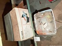 Closed box of TC180A tile cutter on shelf