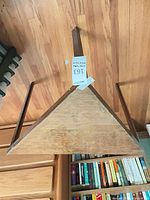 Underside view of triangular wooden table with three legs