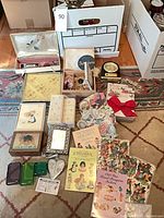 Lot overview showing all ephemera, boxed stationery, clock and trinkets