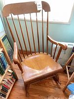 Front view showing full rocking chair, spindle back, seat, arms and rocker legs