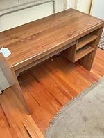 Desk front view showing top, right shelving, leg space