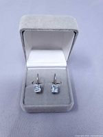pair of aquamarine coloured stone silver drop earrings in box, front view