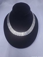 Front view of silver-tone brick-link choker on display bust