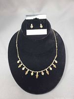 Full view of necklace on display bust with matching earrings above