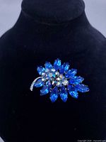 Front view of brooch showing leaf shape and blue rhinestones