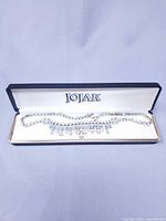 Necklace laid in open Jojak box