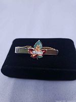 Front view of tie clip showing enamel maple leaf and CANADA text