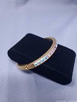 Full view of the hinged bangle on display stand