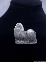 Front view of textured pewter Shih Tzu pin on display stand