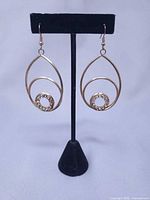 Full view of earring pair on stand showing overall design and size