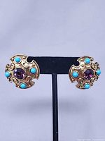 Front view of both earrings showcasing design and stones