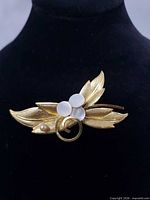 Front view showing leaf motif and mother-of-pearl accents