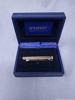 Money clip in open H. Samuel box, full view