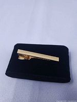 Tie clip on display pad, front view