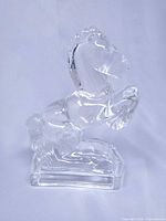 Full view of clear glass rearing horse bookend on base