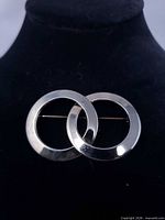 front view of brooch showing interlocking rings design