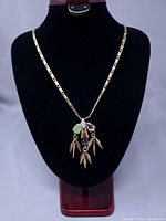 Full view of necklace on bust displaying chain length and pendant