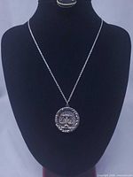 Pendant necklace displayed on bust