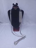 Full view of triple-strand rope chain necklace displayed on bust