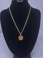 Necklace displayed on bust, showing overall length and pendant placement