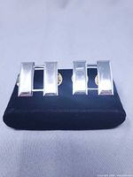 front view of pair of silver captain bars on display pad